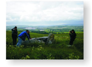 Examining the Neolithic Chambered Cairn at Fivewells, with modern limestone quarrying visible in the background