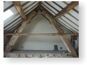 Medieval cruck beams recorded in the farm buildings.