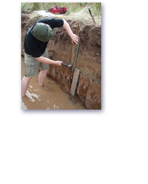 An ARS Ltd representative taking a sediment sample using coring equipment