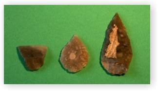 A leaf shaped arrowhead, a chisel and a point