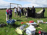 Setting up the site tent at the beginning of the excavation season