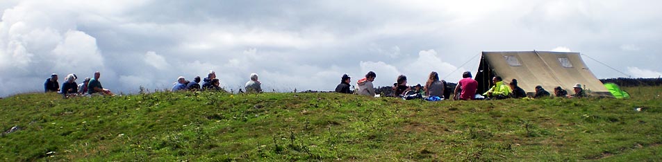 The site tent within the boundary of the hillfort, with excavation team members taking a well earned lunch break.