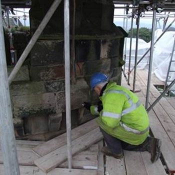 A member of our Historic Buildings team inspecting the stonework of a building whilst undertaking a survey. © Copyright ARS Ltd 2018