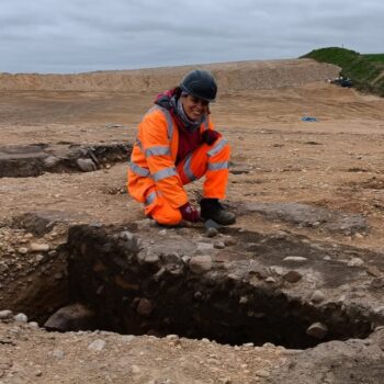 ARS Ltd Project Officer investigating a large midden pit on-site at Lochinver © Copyright ARS Ltd 2022